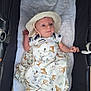 animal_print, baby, blanket, child, clothing, cozy, cute, giraffe, hat, indoors, infant, lying_down, newborn, portrait, soft, stroller, tiger, white_cushion, wide_eyes, zebra