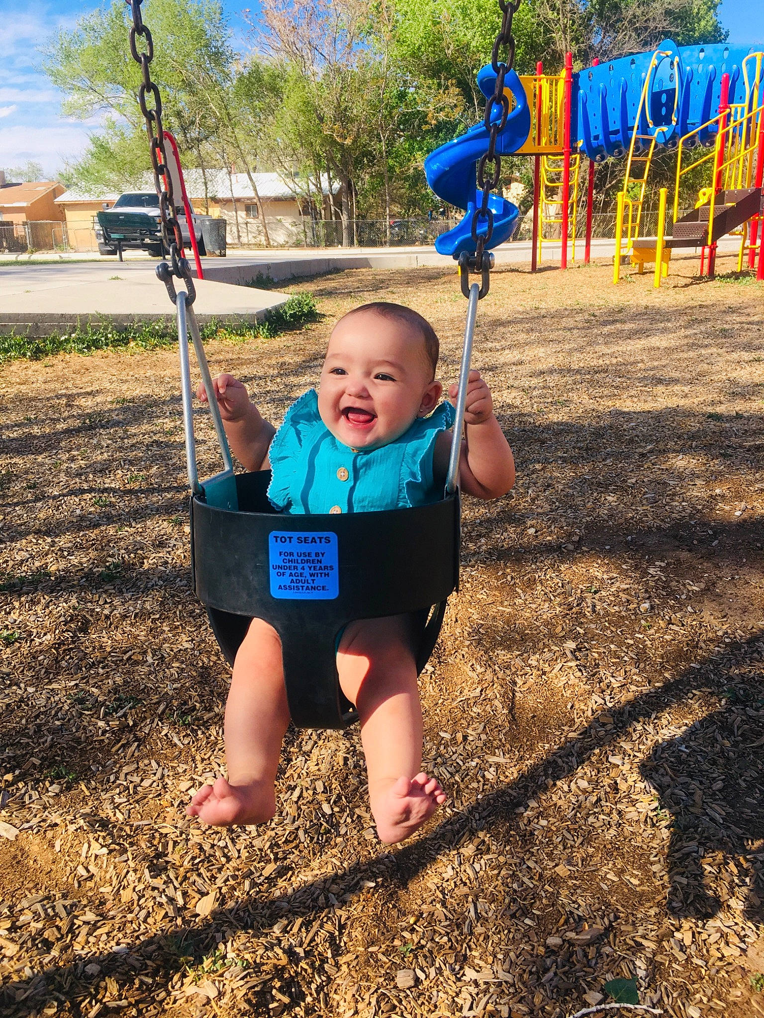 Heavenly is registered to the contest to win money with this photo: baby, city, cloud, electric_blue, fun, grass, happy, leisure, people_in_nature, person, plant, playground, public_space, recreation, sky, smile, summer, swing, t_shirt, toddler
