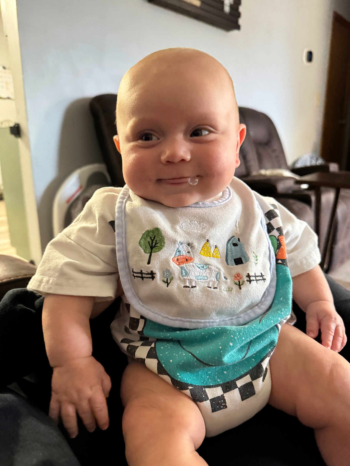 Jace joined the competition — help win amazing prizes! baby, drool, bib, indoor, smile, chubby_cheeks, arm, hand, clothing, seat, furniture, room, person, cute, infant, skin, head, eyes, mouth, expression