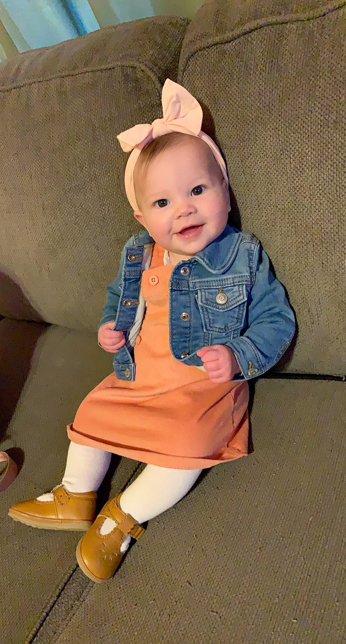 Kinlee joined the competition — help win amazing prizes! baby, baby_toddler_clothing, beige, bonnet, button, cheek, child, child_model, costume_accessory, couch, hair_accessory, headband, hood, joy, overall, person, sitting, sleeve, sock, tan