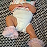 baby, infant, pacifier, onesie, headband, sock, patterned_blanket, laying_down, indoors, cute, child, soft_toys, footwear, pink, white_clothing, newborn, portrait, person, resting, baby_accessory