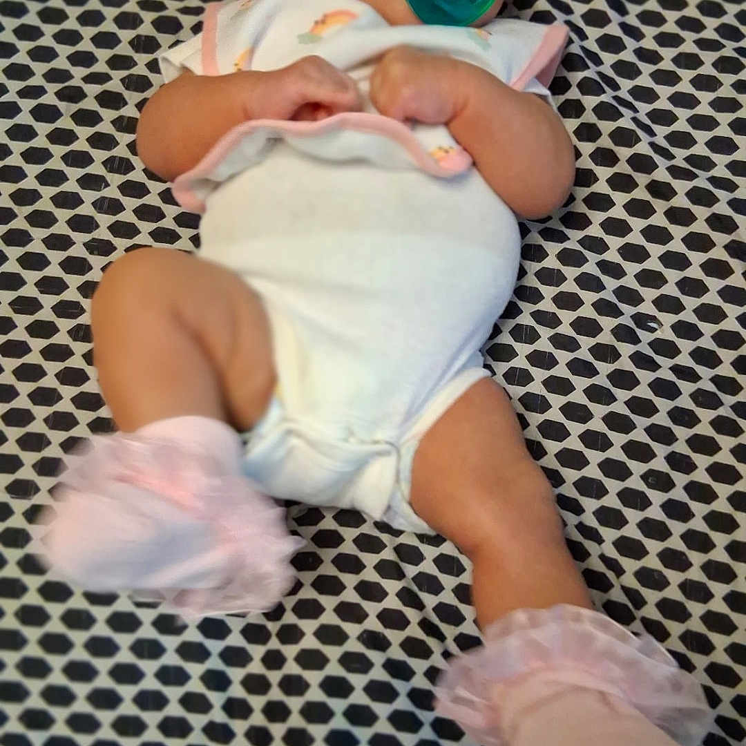 Meuziq joined the competition — help win amazing prizes! baby, infant, pacifier, onesie, headband, sock, patterned_blanket, laying_down, indoors, cute, child, soft_toys, footwear, pink, white_clothing, newborn, portrait, person, resting, baby_accessory