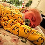 Lanell Davis is registered to the contest to win money with this photo: baby, sleeping, pacifier, yellow_clothing, cloud_pattern, blanket, floral, face, curly_hair, resting, indoors, cozy, child, comfort, soft_lighting, closeup, portrait, peaceful, cute, infant