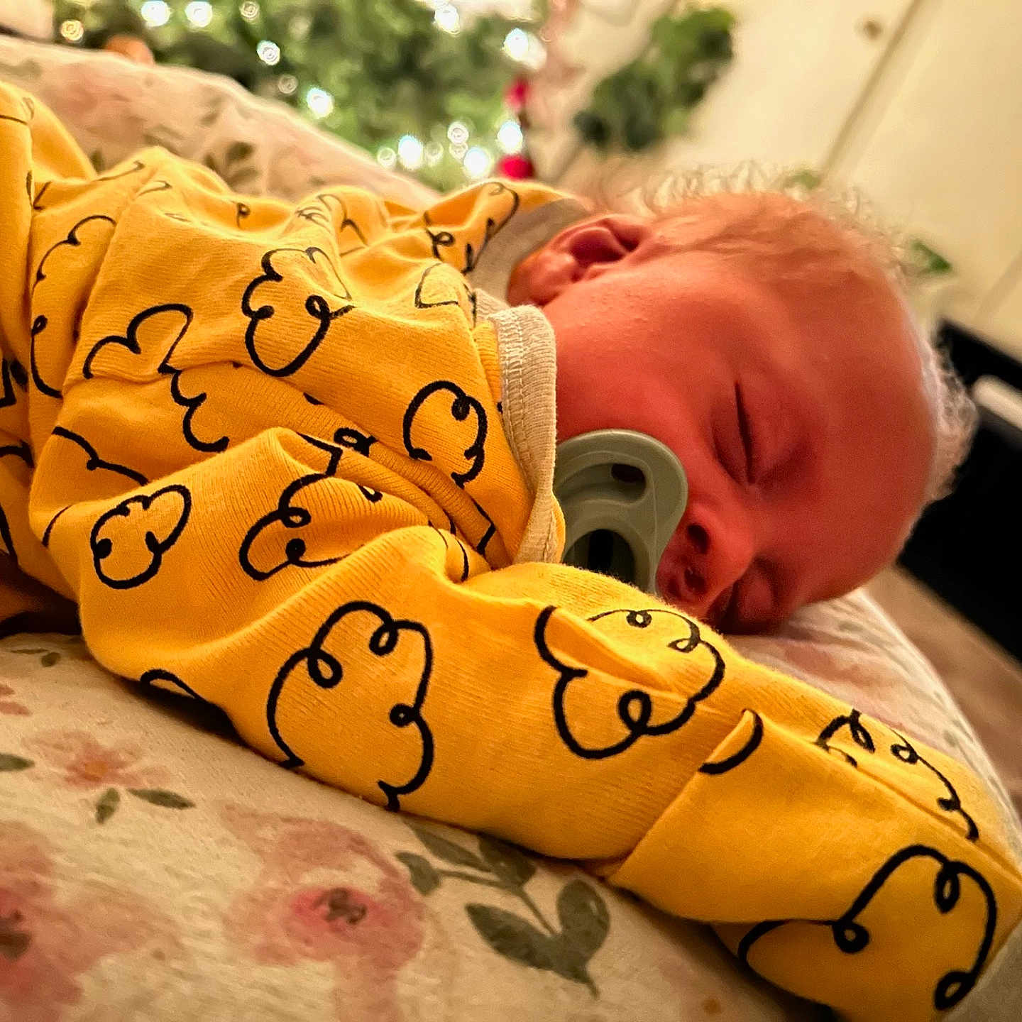 Lanell Davis is registered to the contest to win money with this photo: baby, blanket, child, closeup, cloud_pattern, comfort, cozy, curly_hair, cute, face, floral, indoors, infant, pacifier, peaceful, portrait, resting, sleeping, soft_lighting, yellow_clothing