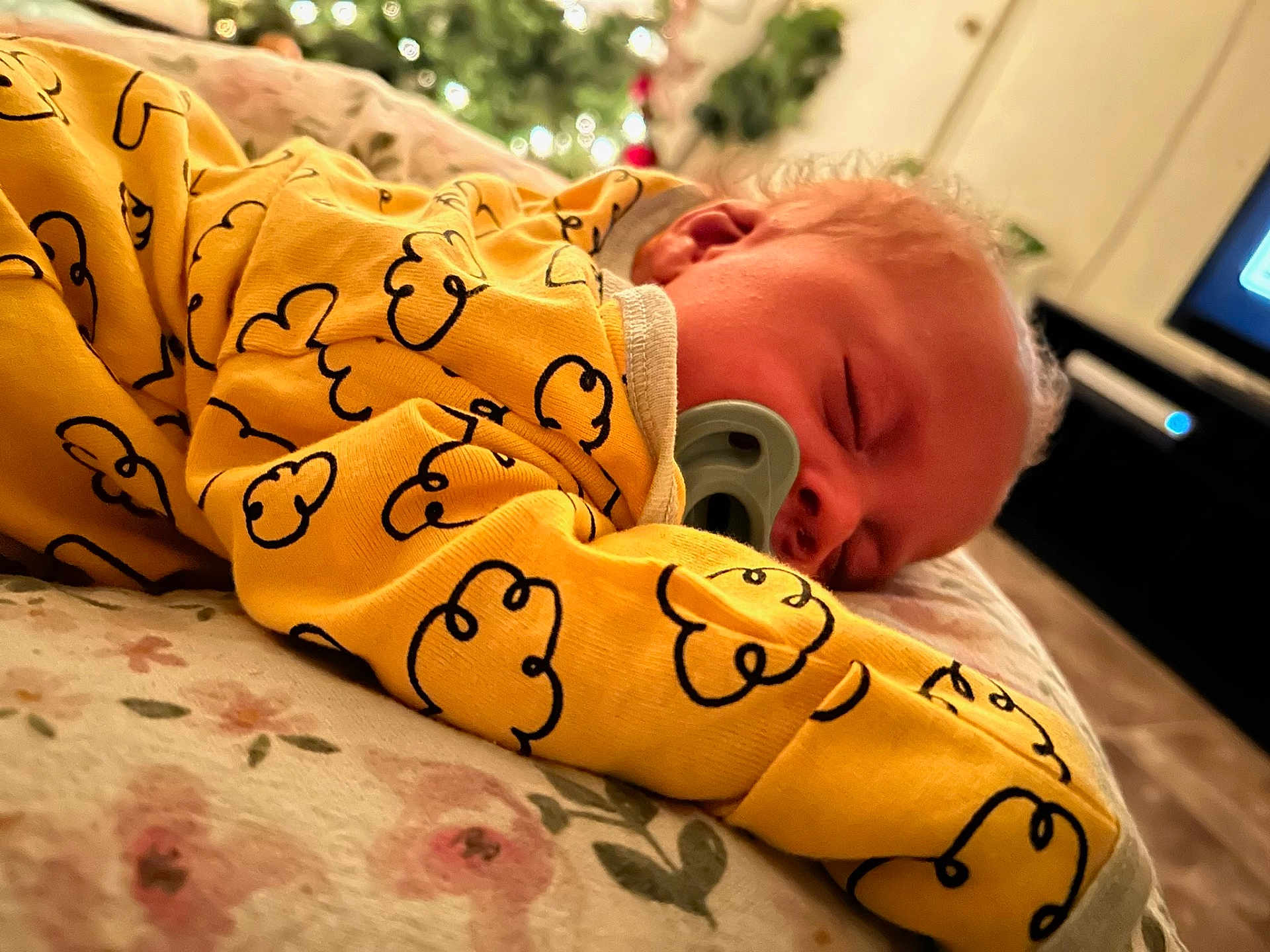 Lanell Davis is registered to the contest to win money with this photo: baby, sleeping, pacifier, yellow_clothing, cloud_pattern, blanket, floral, face, curly_hair, resting, indoors, cozy, child, comfort, soft_lighting, closeup, portrait, peaceful, cute, infant