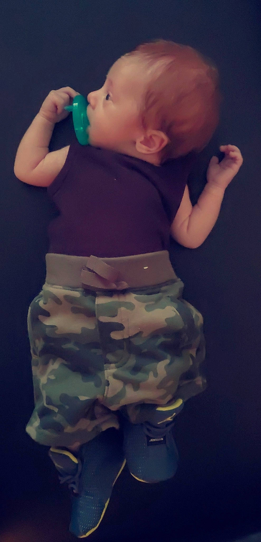 Xaiver is registered to the contest to win money with this photo: arm, baby_toddler_clothing, camouflage, finger, flash_photography, gesture, hand, head, human_body, joint, military_camouflage, muscle, neck, organ, person, photograph, shoulder, sleeve, standing, stomach