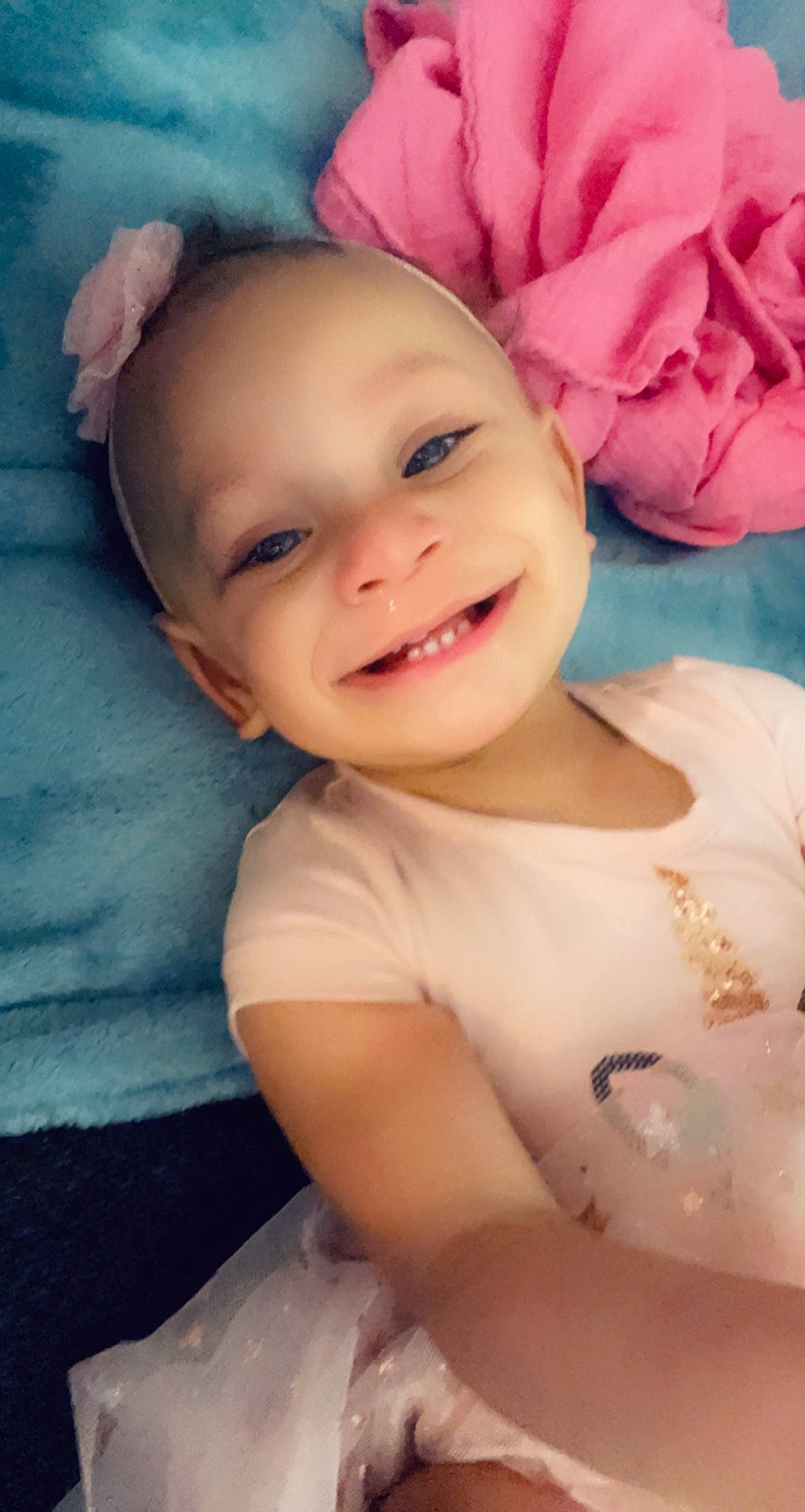 Bryleigh is registered to the contest to win money with this photo: arm, baby, baby_toddler_clothing, cheek, eye, eyebrow, face, flash_photography, happy, head, headgear, human_body, iris, joy, lip, mouth, person, pink, purple, skin