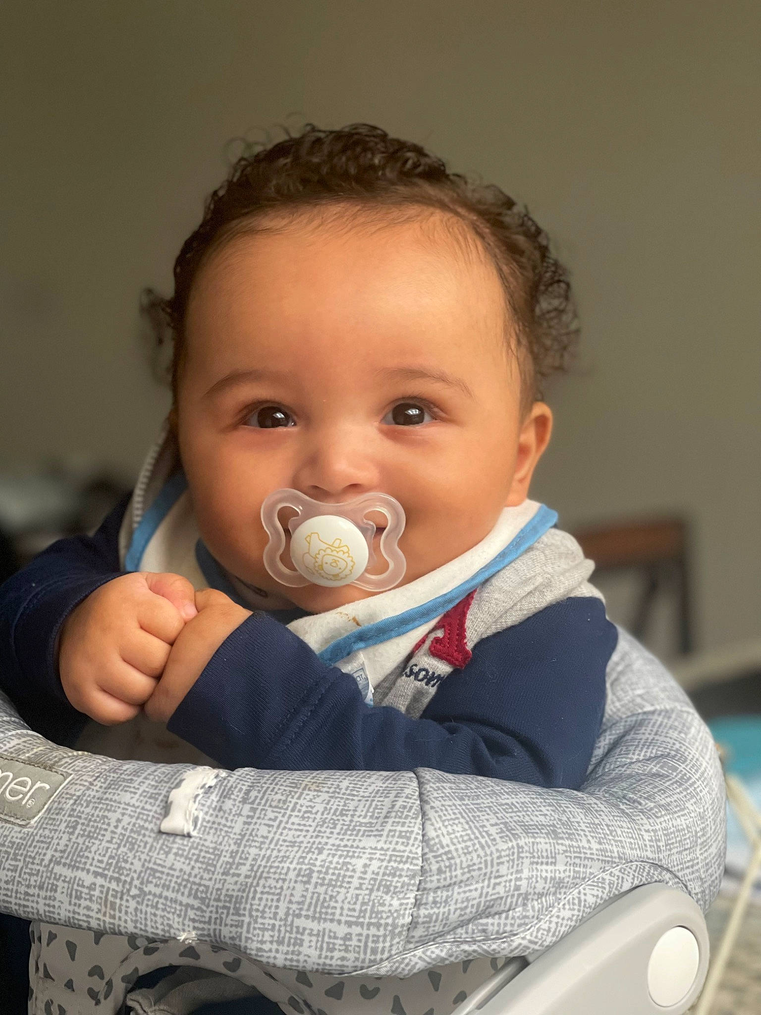 Kobe is registered to the contest to win money with this photo: audio_equipment, baby, baby_products, baby_toddler_clothing, chair, cheek, child, comfort, eye, eyelash, flash_photography, fun, gesture, happy, human_body, iris, nose, person, sitting, skin