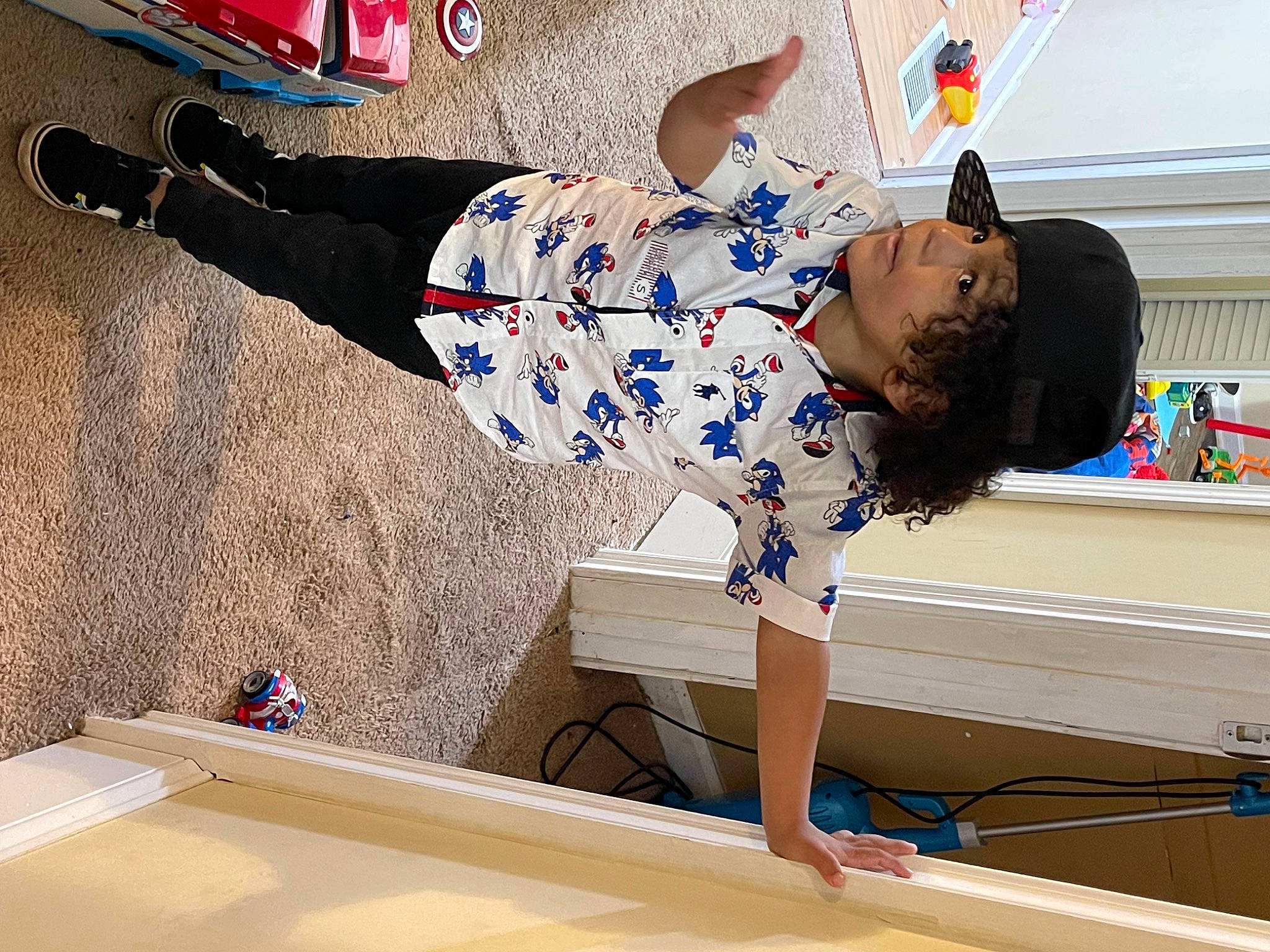 Grayson is registered to the contest to win money with this photo: balance, barefoot, blue, elbow, electric_blue, fun, happy, human_leg, knee, leg, leisure, person, photograph, recreation, shorts, snapshot, street_fashion, t_shirt, thigh, white