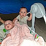 Tessa is registered to the contest to win money with this photo: baby, infant, blanket, pink_blanket, baby_seat, toddler, indoor, couch, blue_blanket, child, curious, expression, floor, holding, hand, clothing, face, person, cute, portrait