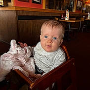 Huntlee joined the competition — help win amazing prizes! baby, blue_eyes, bunny, casual_clothing, child, childhood, curious, cute, face, high_chair, indoor, infant, person, plush_toy, portrait, restaurant, seated, soft_toy, wooden_furniture, young