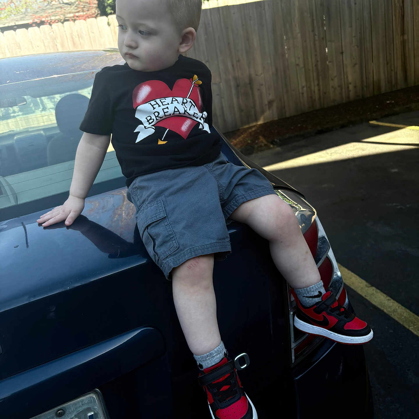 Jaiden Slayer is registered to the contest to win money with this photo: boy, car, child, clothing, face, footwear, head, licenseplate, machine, male, person, photography, portrait, shoe, shorts, sneaker, spoke, t_shirt, transportation, vehicle