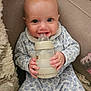 Aria is registered to the contest to win money with this photo: baby, infant, bottle, milk, cute, smiling, blue, onesie, clothing, sitting, blanket, couch, soft, hand, face, expression, child, indoors, portrait, happy