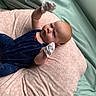 Leah is registered to the contest to win money with this photo: baby, bed, blanket, bodypart, clothing, cushion, face, finger, furniture, glove, hand, head, homedecor, hosiery, newborn, person, photography, portrait, sleeping, sock