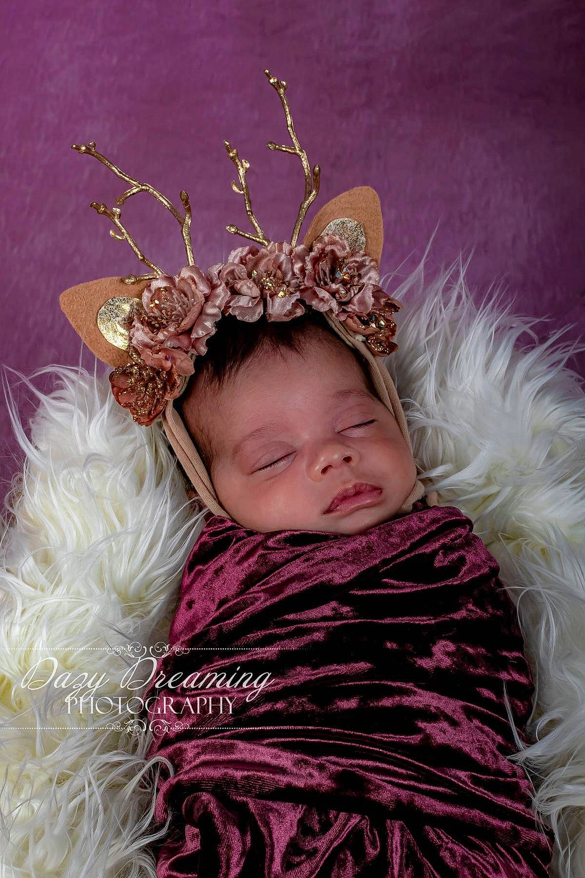 Alaiyah joined the competition — help win amazing prizes! baby, baby_toddler_clothing, costume_hat, crown, event, fashion_accessory, feather, fur, grass, hair_accessory, happy, headband, headgear, headpiece, jewellery, magenta, pattern, person, pink, toddler