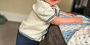 Cobie is registered to the contest to win money with this photo: baby, barefoot, blanket, blue_eyes, carpet, child, clothing, couch, cute, furniture, happy, home, indoor, knitwear, leaning, person, portrait, smile, toddler, young_child