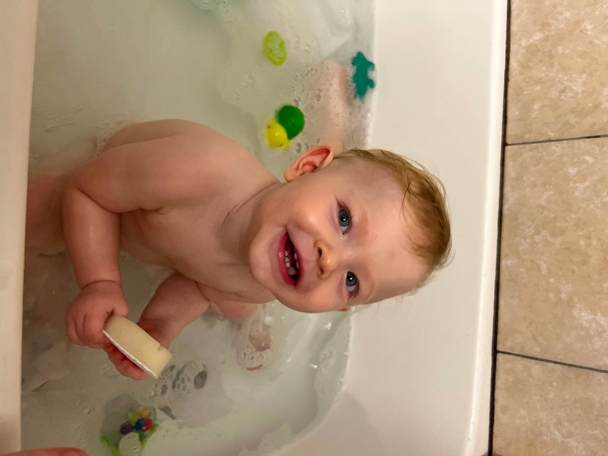 Mason is registered to the contest to win money with this photo: baby, baby_bathing, bathing, bathroom, cheek, chest, eye, eyebrow, floor, flooring, fun, happy, iris, joy, lip, mouth, nose, person, plumbing_fixture, skin