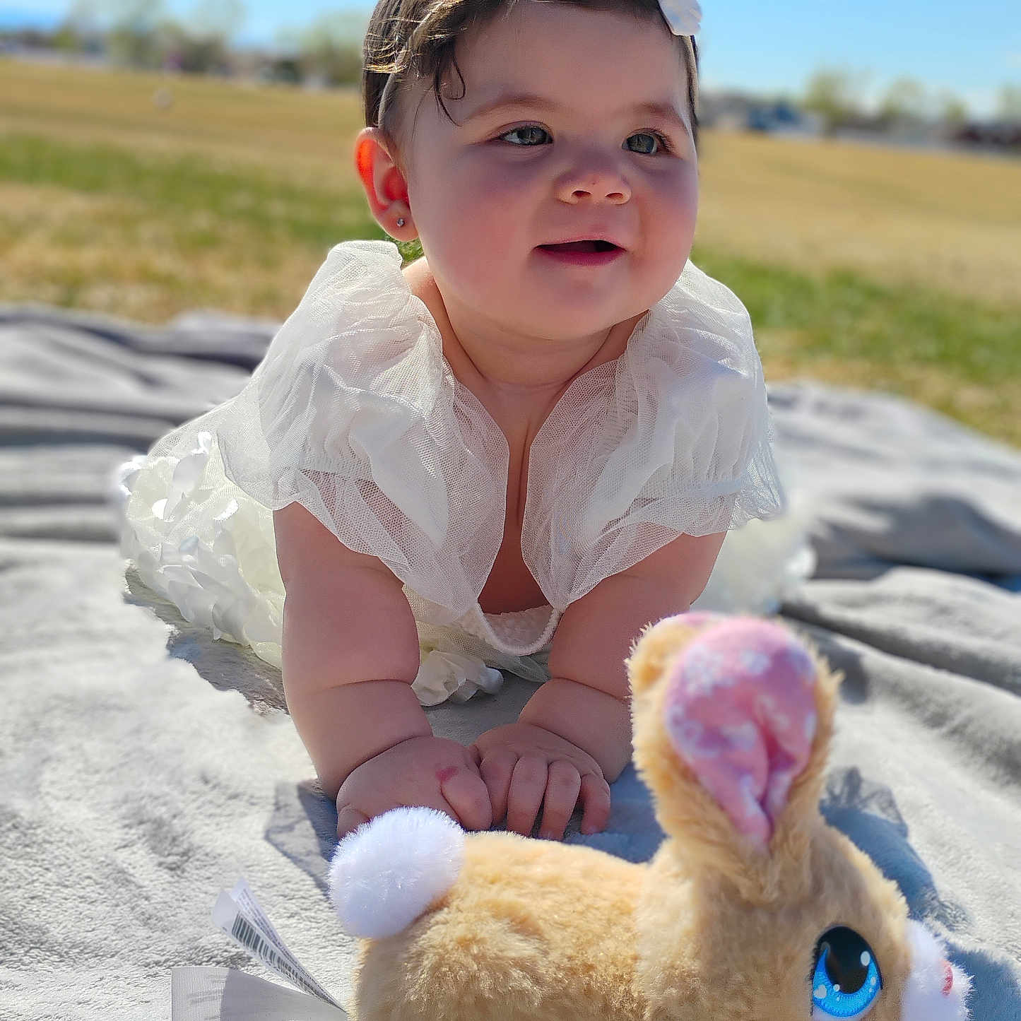 Isabella is registered to the contest to win money with this photo: animal, baby, bodypart, clothing, dress, face, finger, hand, happy, hat, head, person, photography, plush, portrait, rabbit, sitting, smile, teddybear, toy