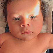 Michael joined the competition — help win amazing prizes! baby, infant, face, skin, hair, eyes, portrait, closeup, child, newborn, young, cute, expression, lying_down, soft_surface, natural_light, shadow, indoors, human, person