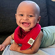 Enzo joined the competition — help win amazing prizes! baby, smiling, red_bib, blanket, indoor, happy, infant, face, cute, child, clothing, pacifier, couch, portrait, skin, head, expression, light, closeup, person