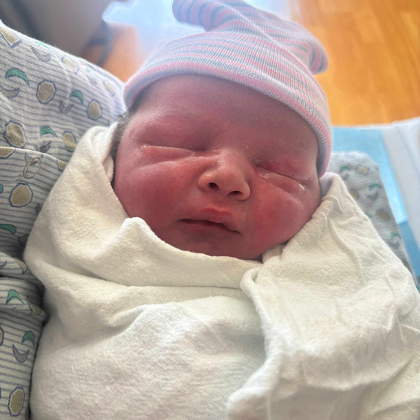 Emmett is registered to the contest to win money with this photo: baby, bed, blanket, child, closeup, cute, face, hat, headwear, hospital, indoor, infant, newborn, pattern, portrait, resting, skin, sleeping, soft_light, swaddled