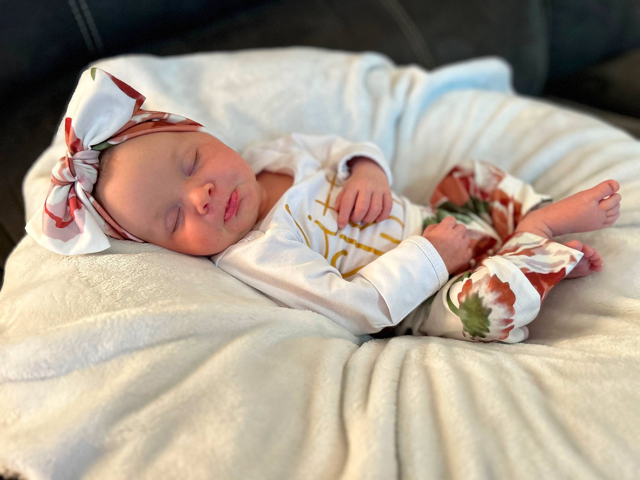 Tatum is registered to the contest to win money with this photo: arm, baby, baby_sleeping, baby_toddler_clothing, bedding, bedtime, child, comfort, dress, eye, face, finger, hand, head, human_body, human_leg, linens, person, sitting, skin