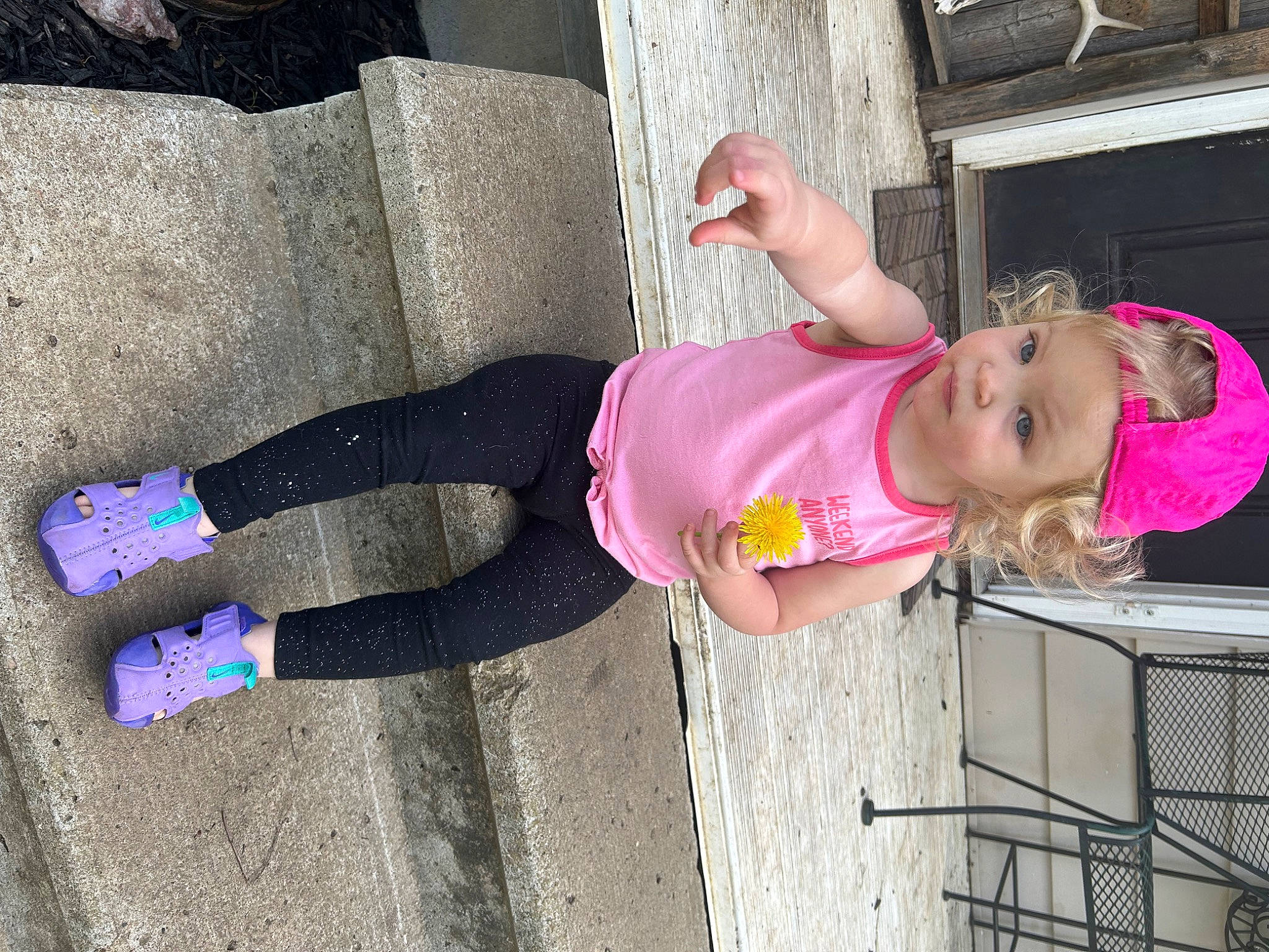 Tinlee is registered to the contest to win money with this photo: asphalt, child, concrete, fun, hat, human_leg, knee, leg, leisure, magenta, person, pink, sandal, smile, sneakers, sock, sunglasses, thigh, tire, toddler