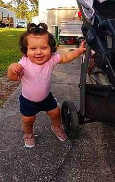 Karlee is registered to the contest to win money with this photo: arm, auto_part, baby, child, joy, leg, person, photography, physical_fitness, play, product, shoulder, tire, toddler, vehicle, wheel