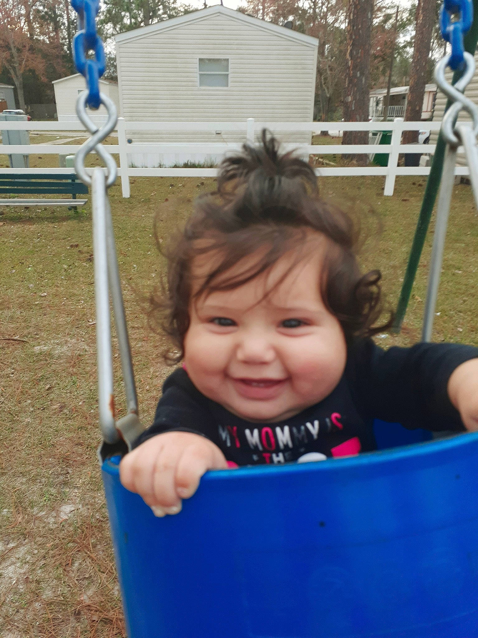 Karlee is registered to the contest to win money with this photo: baby, child, city, fun, happy, human_settlement, joy, outdoor_play_equipment, person, play, playground, public_space, recreation, smile, swing, toddler, tree