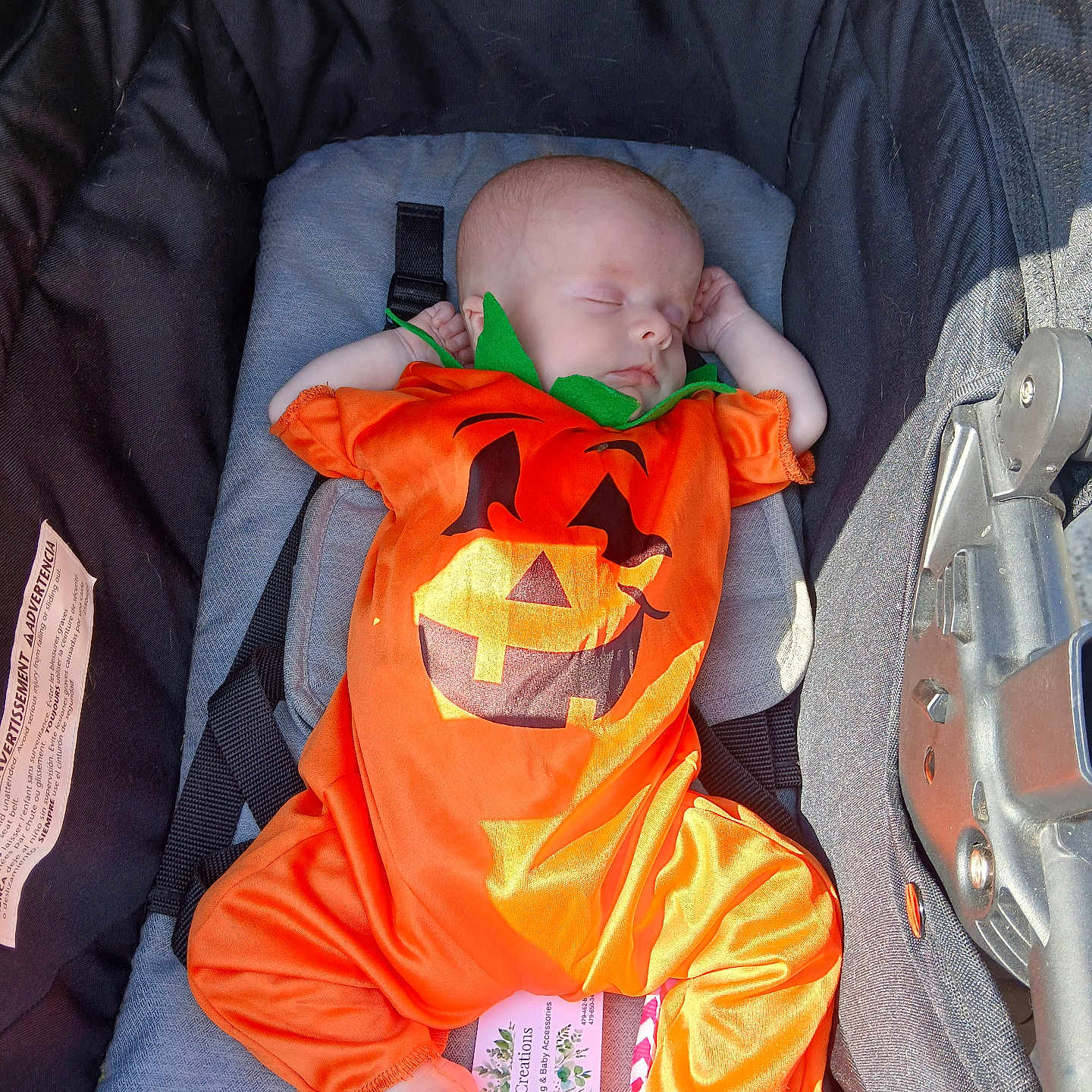 Temperance is registered to the contest to win money with this photo: baby, baby_accessory, baby_boy, baby_clothing, baby_girl, child, costume, cute, footwear, holiday, infant, infant_clothing, orange, peaceful, portrait, pumpkin_costume, resting, sleeping, stroller, sunlight