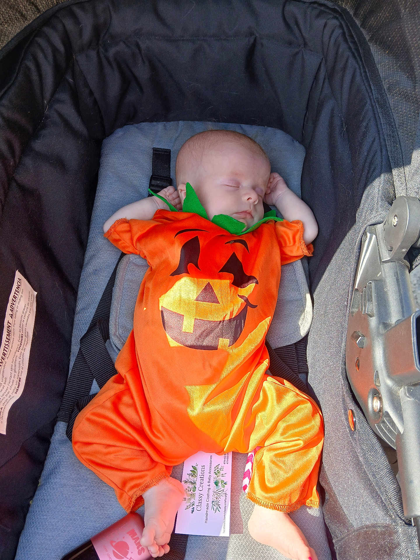Temperance is registered to the contest to win money with this photo: baby, infant, sleeping, pumpkin_costume, orange, stroller, baby_clothing, footwear, peaceful, cute, child, portrait, sunlight, resting, holiday, costume, baby_accessory, infant_clothing, baby_boy, baby_girl
