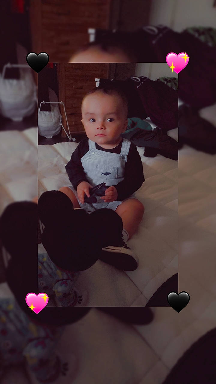 Jeremy is registered to the contest to win money with this photo: baby, balloon, child, design, event, facial_expression, flash_photography, floor, flooring, fun, happy, lighting, magenta, material_property, person, pink, purple, room, sitting, toddler