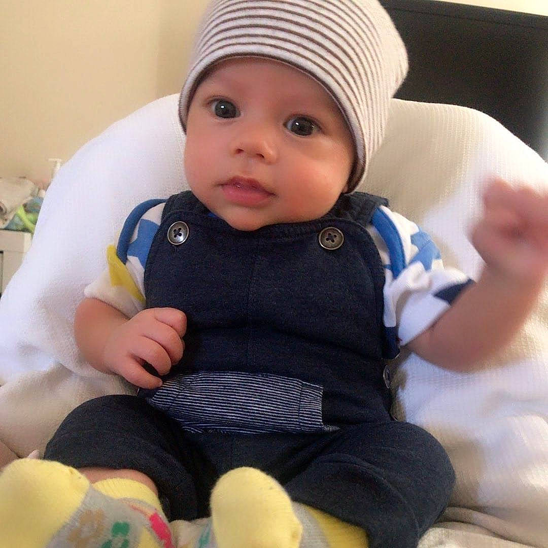 Phoenix is registered to the contest to win money with this photo: baby, baby_in_car_seat, baby_products, beanie, bonnet, cap, cheek, child, cool, headgear, headwear, person, product, sitting, skin, toddler