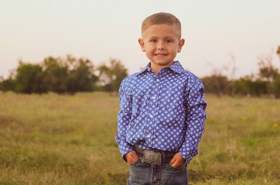 Liam joined the competition — help win amazing prizes! agriculture, collar, dress_shirt, electric_blue, flash_photography, grass, grassland, happy, joy, landscape, meadow, people_in_nature, person, plaid, plant, prairie, sky, sleeve, smile, t_shirt