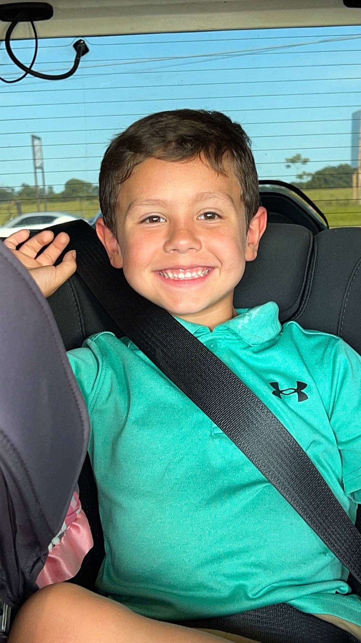 Liam is registered to the contest to win money with this photo: auto_part, automotive_window_part, car_seat, child, cool, driving, electric_blue, family_car, grass, happy, joy, leisure, luxury_vehicle, motor_vehicle, person, personal_protective_equipment, sky, smile, travel, tree