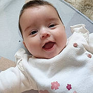 Sixtine a rejoint le concours — aidez-le/la à gagner de superbes lots ! arms_outstretched, baby, carpet, child, clothing, cute, expression, face, flower, happy, indoors, infant, joyful, lying_down, pink, playmat, portrait, smiling, soft_lighting, white