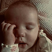 Heidi is registered to the contest to win money with this photo: baby, sleeping, hand, face, infant, closeup, soft_lighting, blanket, clothing, peaceful, portrait, cute, rest, young_child, skin, eyelashes, mouth, fingers, textile, cozy