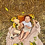 Mario is registered to the contest to win money with this photo: baby, blanket, sunflower, teddy_bear, toy_car, hay, pillow, outdoor, child, nature, cute, portrait, flower, wooden_toy, relaxing, summer, grass, playtime, soft, innocence