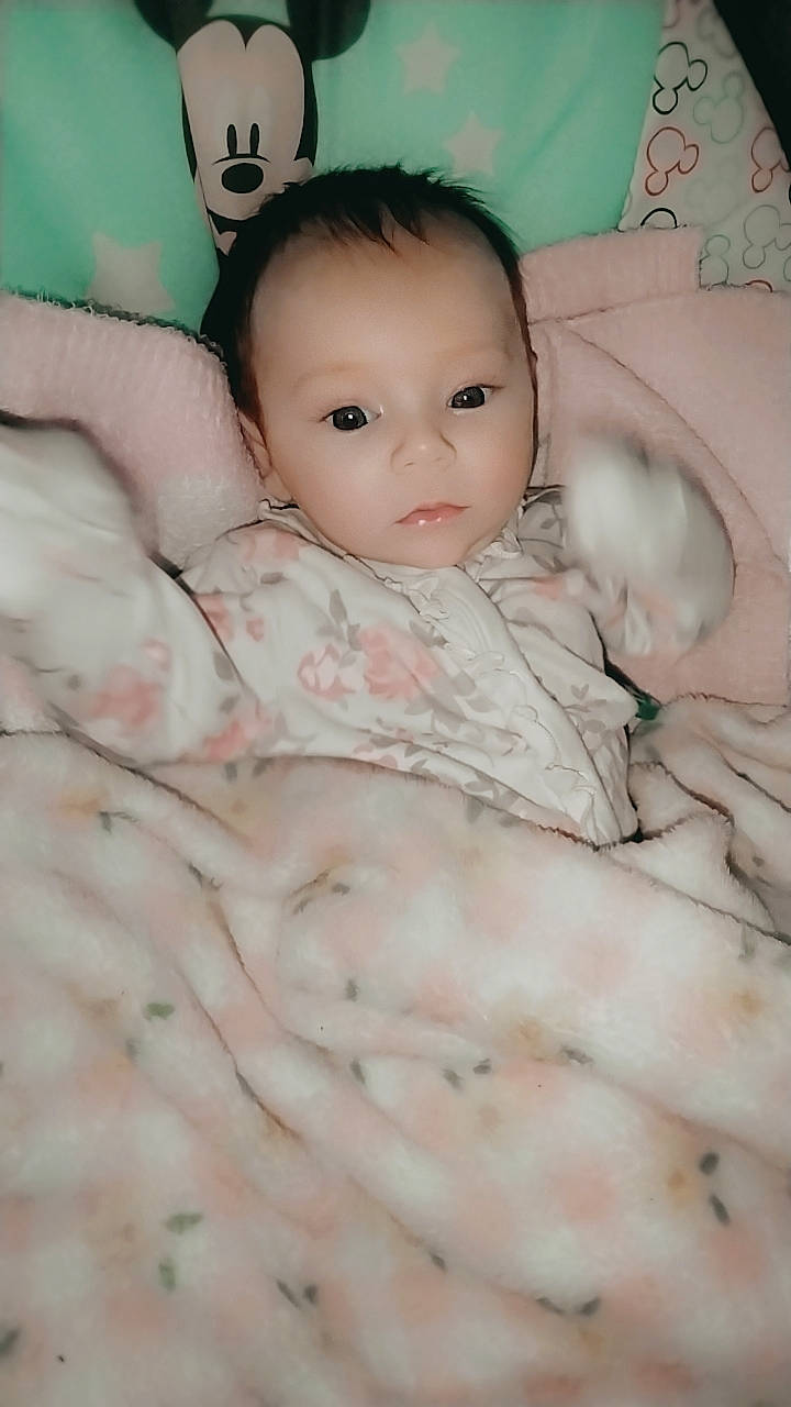 Leilani joined the competition — help win amazing prizes! baby, bedding, cheek, chin, comfort, eye, eyebrow, eyelash, face, fur, head, headgear, iris, linens, nose, pattern, person, pink, skin, textile