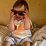 Ayden participe au concours pour gagner de l'argent avec cette photo : toddler, child, sunglasses, smile, happy, adidas, clothing, bed, blanket, indoor, person, foot, casual, shorts, shirt, head, hair, skin, playful, fun