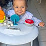 Lovannah participe au concours pour gagner de l'argent avec cette photo : baby, walker, toy, smiling, indoor, child, face, floor, kitchen, highchair, furniture, person, cute, play, happiness, home, infant, clothing, floor_tile, expression