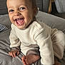 toddler, child, smiling, happy, crawling, pajamas, indoors, cozy, soft, gray, cream, brown, face, hand, foot, furniture, pillow, couch, home, person