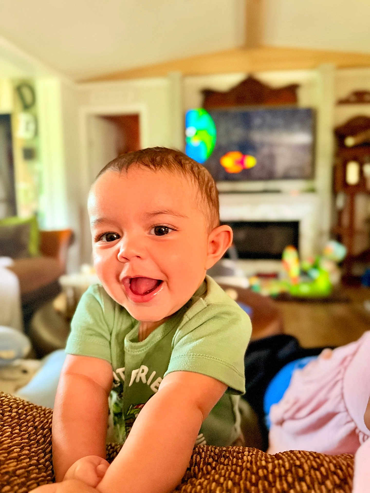 Jeremiah joined the competition — help win amazing prizes! toddler, child, smiling, happy, indoor, living_room, short_hair, green_shirt, face, arms, expression, person, home, furniture, blurred_background, cute, joy, young_child, portrait, casual