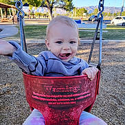 Rylee joined the competition — help win amazing prizes! toddler, child, swing, playground, outdoor, park, smiling, happy, clothing, sitting, face, person, daylight, trees, mountains, woodchips, play, fun, recreation, casual