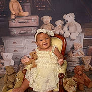 Esme joined the competition — help win amazing prizes! baby, child, teddy_bear, stuffed_animal, armchair, dress, headband, vintage, attic, furniture, smile, portrait, toy, cute, seated, plush, wood, fabric, happy, decor