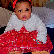 Haven is registered to the contest to win money with this photo: baby, bed, boots, child, clothing, cozy, curious, cute, fashion, headband, indoor, infant, pillow, plaid, portrait, red_dress, sitting, smiling, white_jacket, wooden_wall
