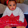 baby, bed, boots, child, clothing, cozy, curious, cute, fashion, headband, indoor, infant, pillow, plaid, portrait, red_dress, sitting, smiling, white_jacket, wooden_wall