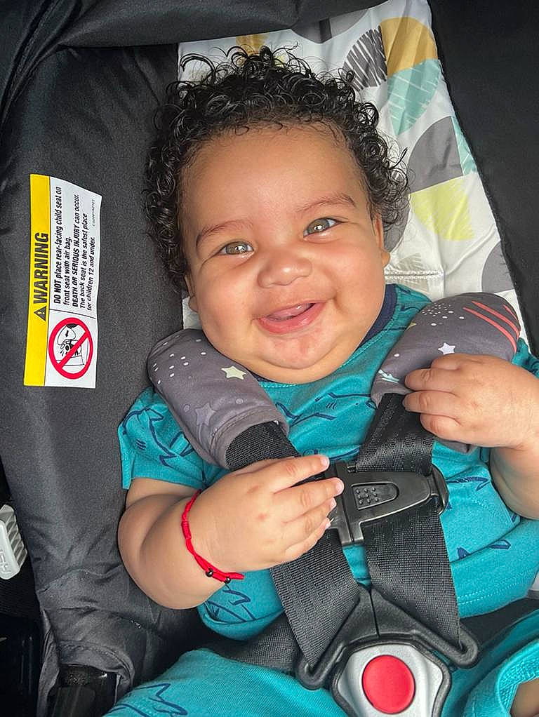 Brandon is registered to the contest to win money with this photo: baby_carriage, cheek, cool, eye, finger, gesture, hand, happy, head, human, iris, joy, nose, organ, person, photograph, pink, product, red, skin