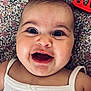 Mya a rejoint le concours — aidez-le/la à gagner de superbes lots ! baby, smiling, close_up, face, infant, happy, child, white_clothing, blanket, pattern, toy, red_toy, lying_down, portrait, cute, cheerful, skin, head, eyes, mouth
