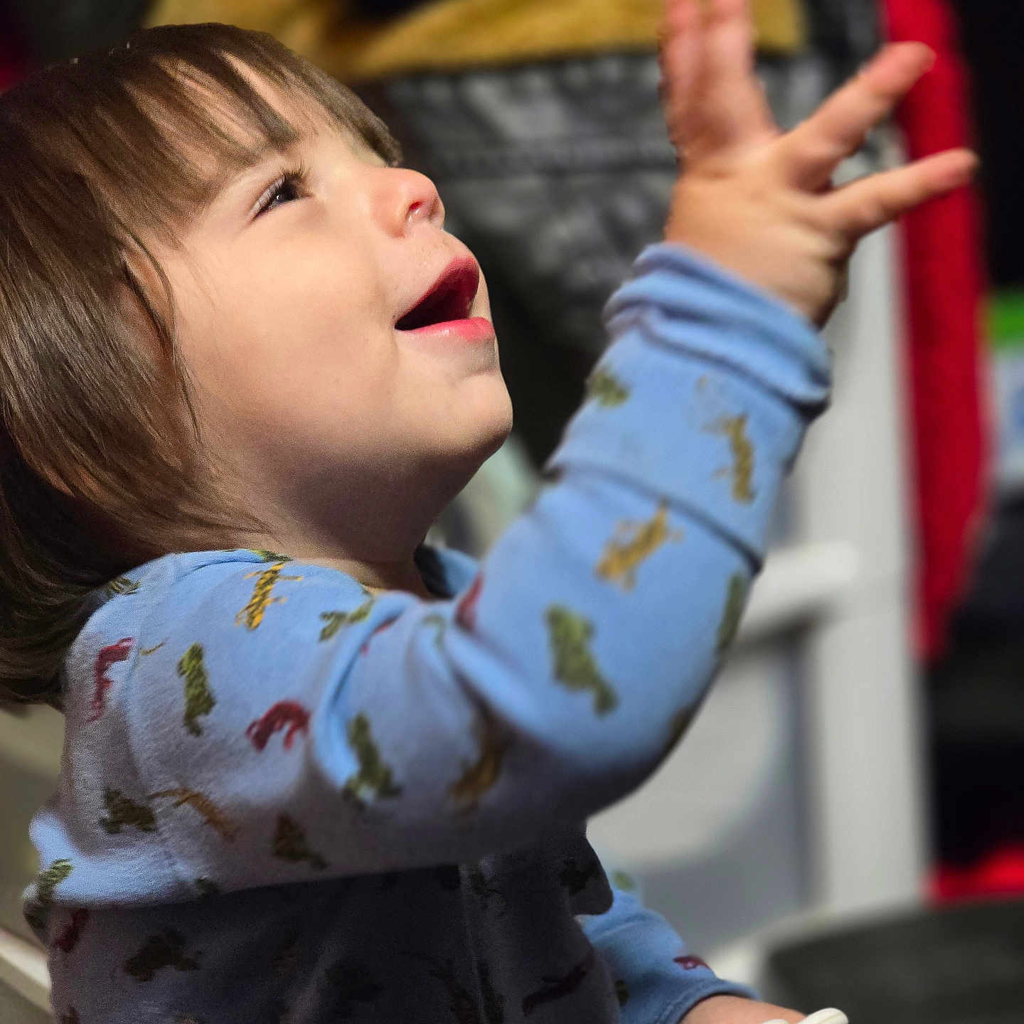 Preston joined the competition — help win amazing prizes! baby, blurred_background, child, clothing, dinosaur_pattern, expression, face, hand, happy, indoor, onesie, person, playful, portrait, short_hair, smile, toddler, toy, warm_light, young_child